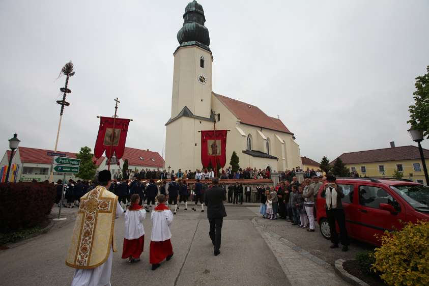ErstKommunion in Wolfsbach Vor der Kirche wie auf der Bühne stehen die Eltern, Paten und Verwandten, während die Kinder angeführt von der Blasmusikkapelle und begleitet von Pfarrer...